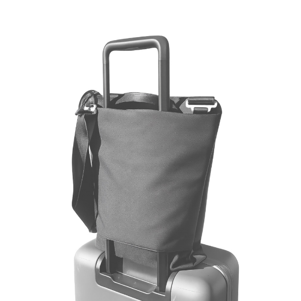 The suitcase pass-thru pocket being used with a carry-on suitcase